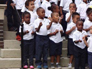 A group of children are standing on a set of stairs