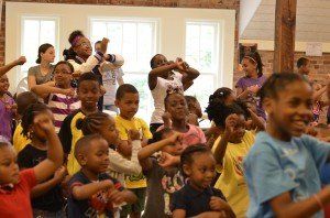 A group of children are dancing together in a room
