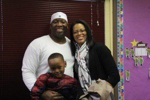 A man and woman are posing for a picture with a child