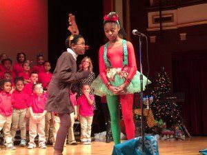 A girl in a reindeer costume is standing next to a girl in a tutu