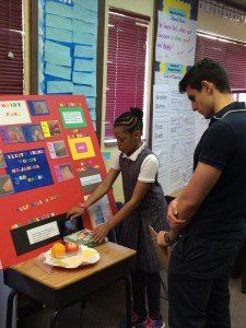 A boy and a girl are working on a project in a classroom.