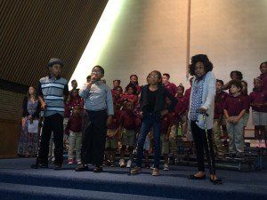 A group of children are standing on a stage.