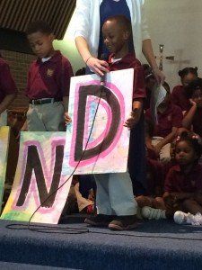 A little boy is holding a sign that says nd