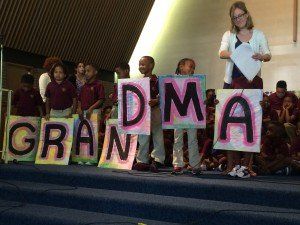 A group of children holding up signs that say dma grantia