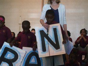 A group of children are holding signs that say pan