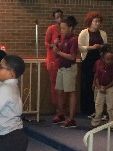 A group of people standing in front of a microphone