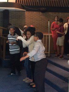 A group of people are dancing in a room.