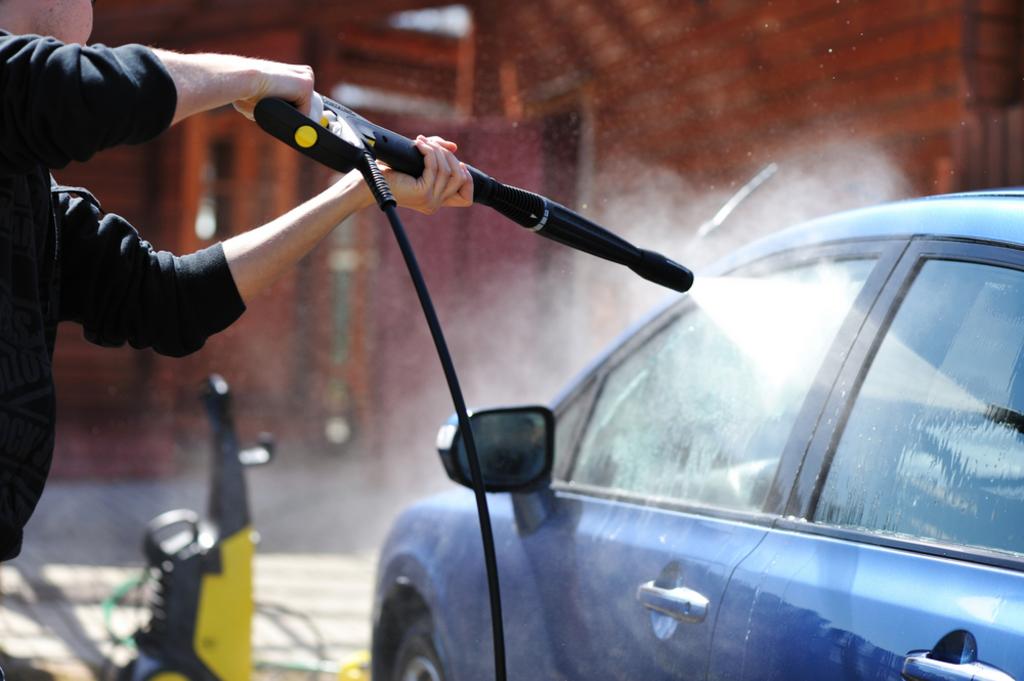 washing a car using pressure washer