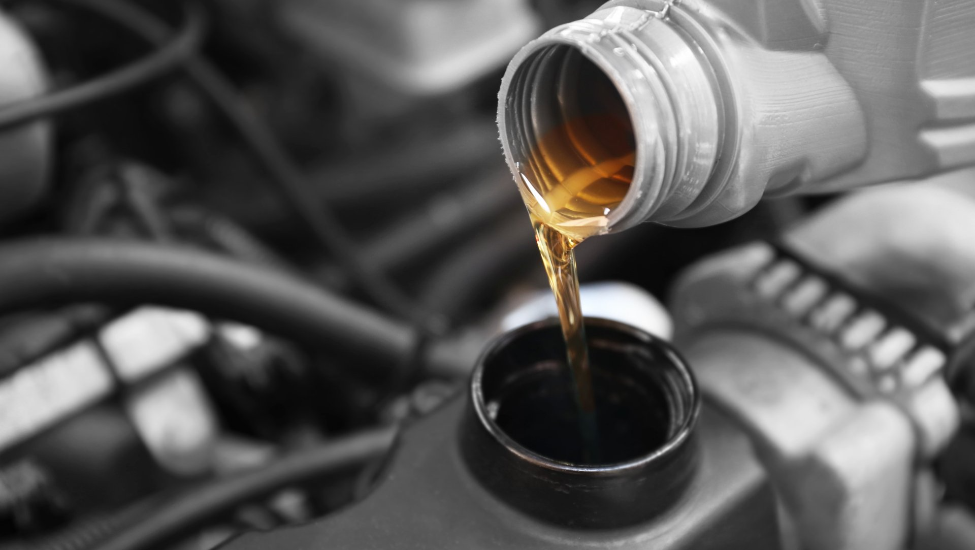 pouring oil in the car engine