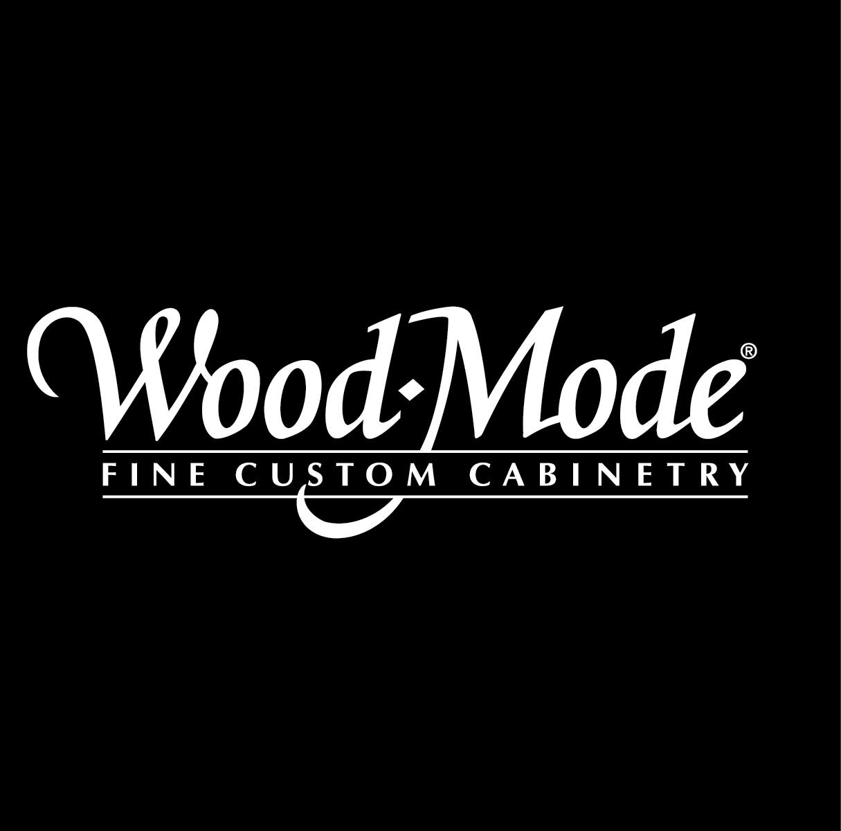The logo for wood mode fine custom cabinetry is white on a black background.