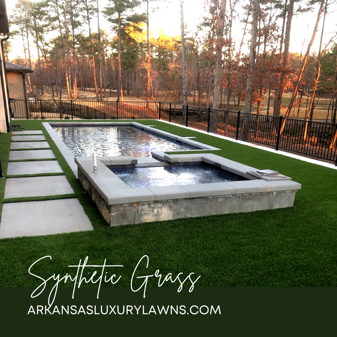 A large swimming pool surrounded by synthetic grass in a backyard.