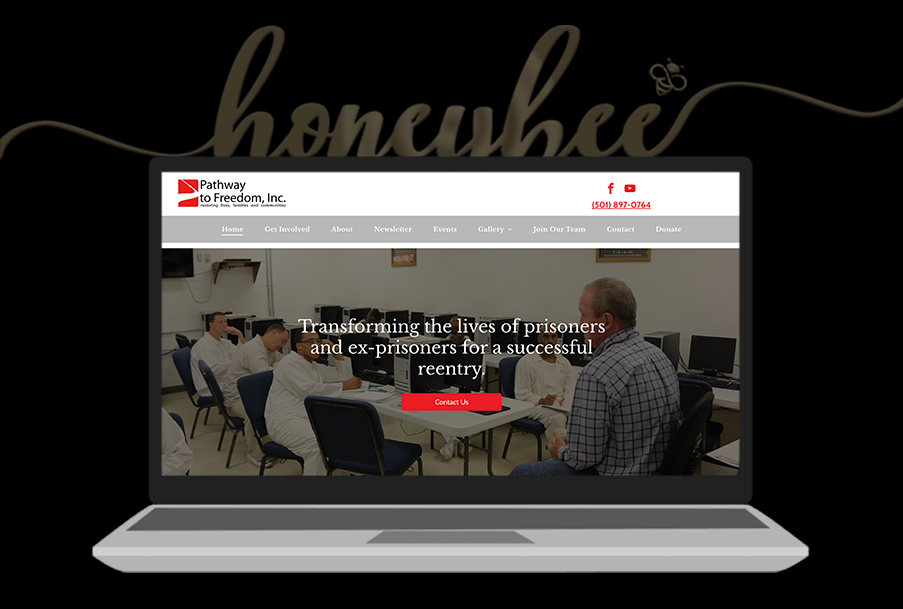 A laptop computer is open to a website with a picture of two men sitting at a table.