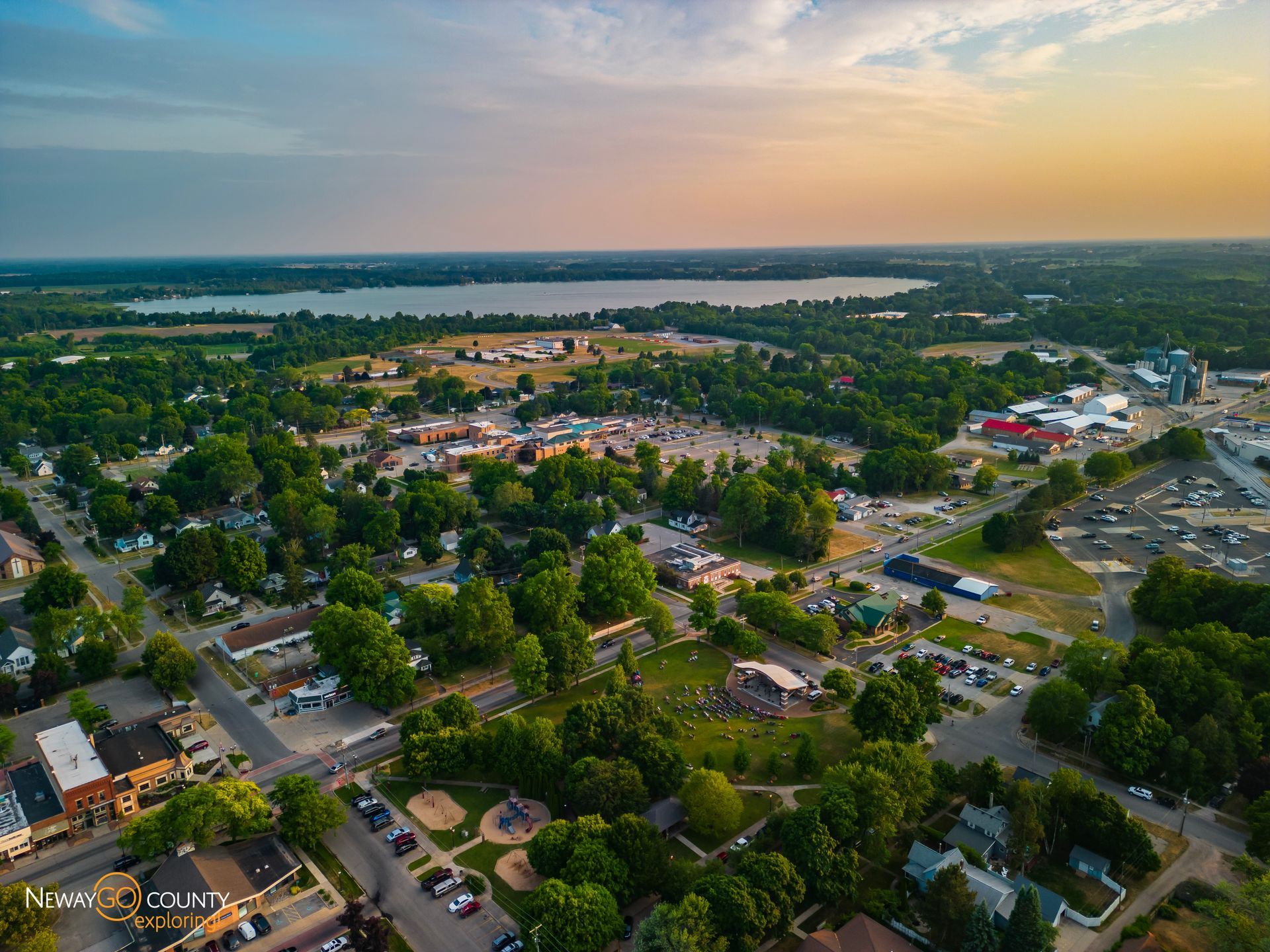 An aerial view of a small town with a lake in the background.