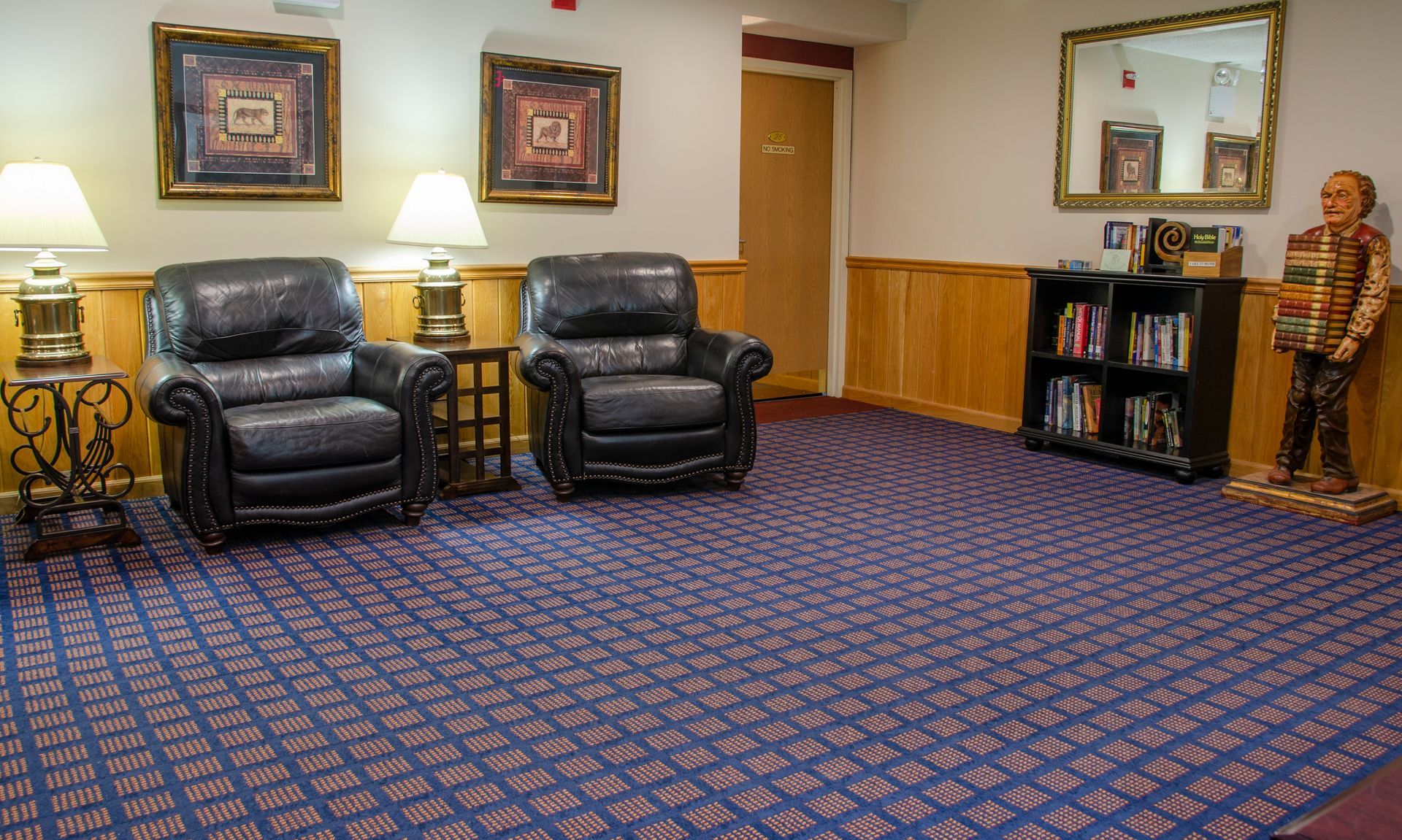 There are two chairs and a bookshelf in the room.