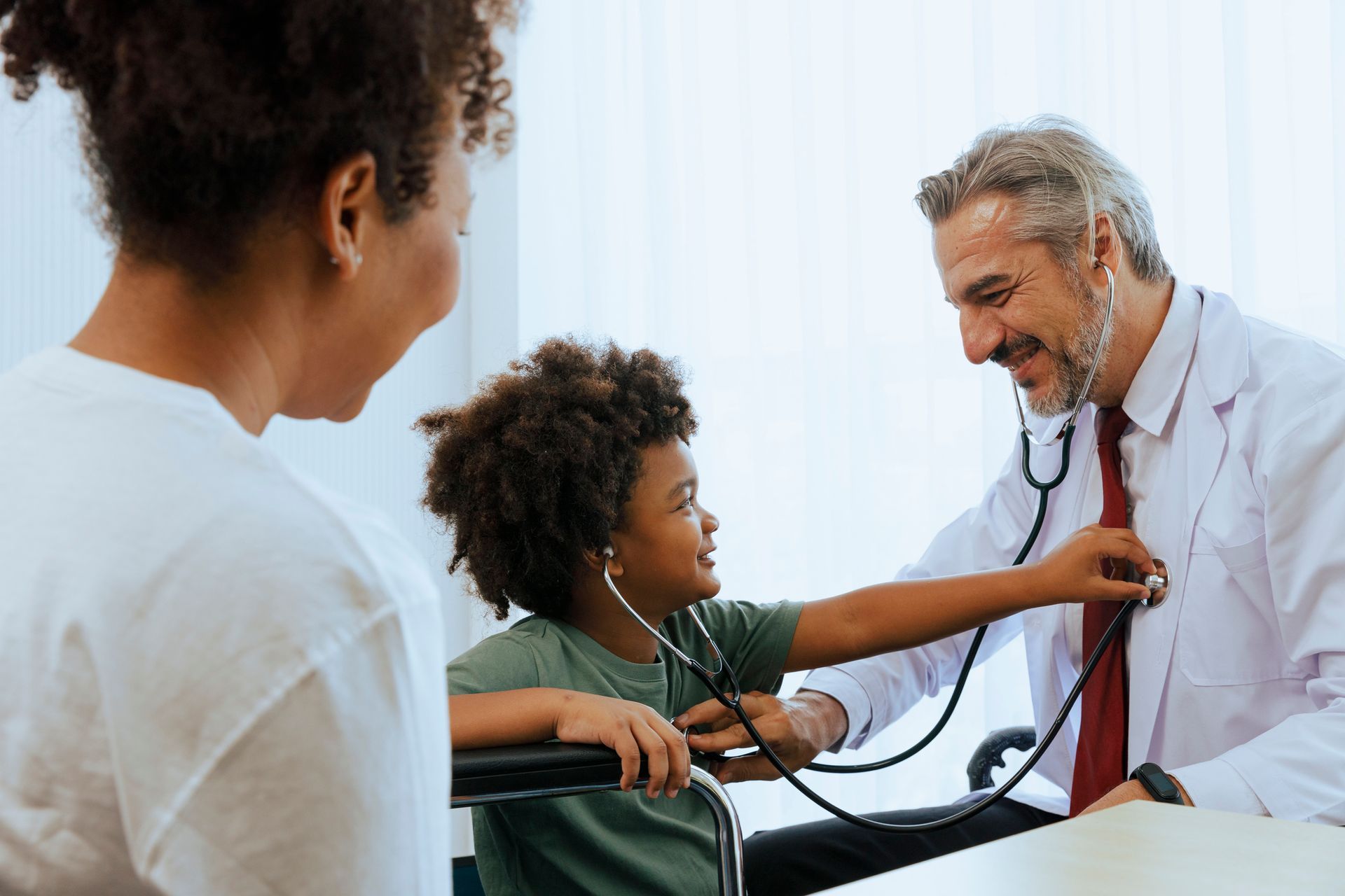 A doctor is listening to a child's heartbeat with a stethoscope.