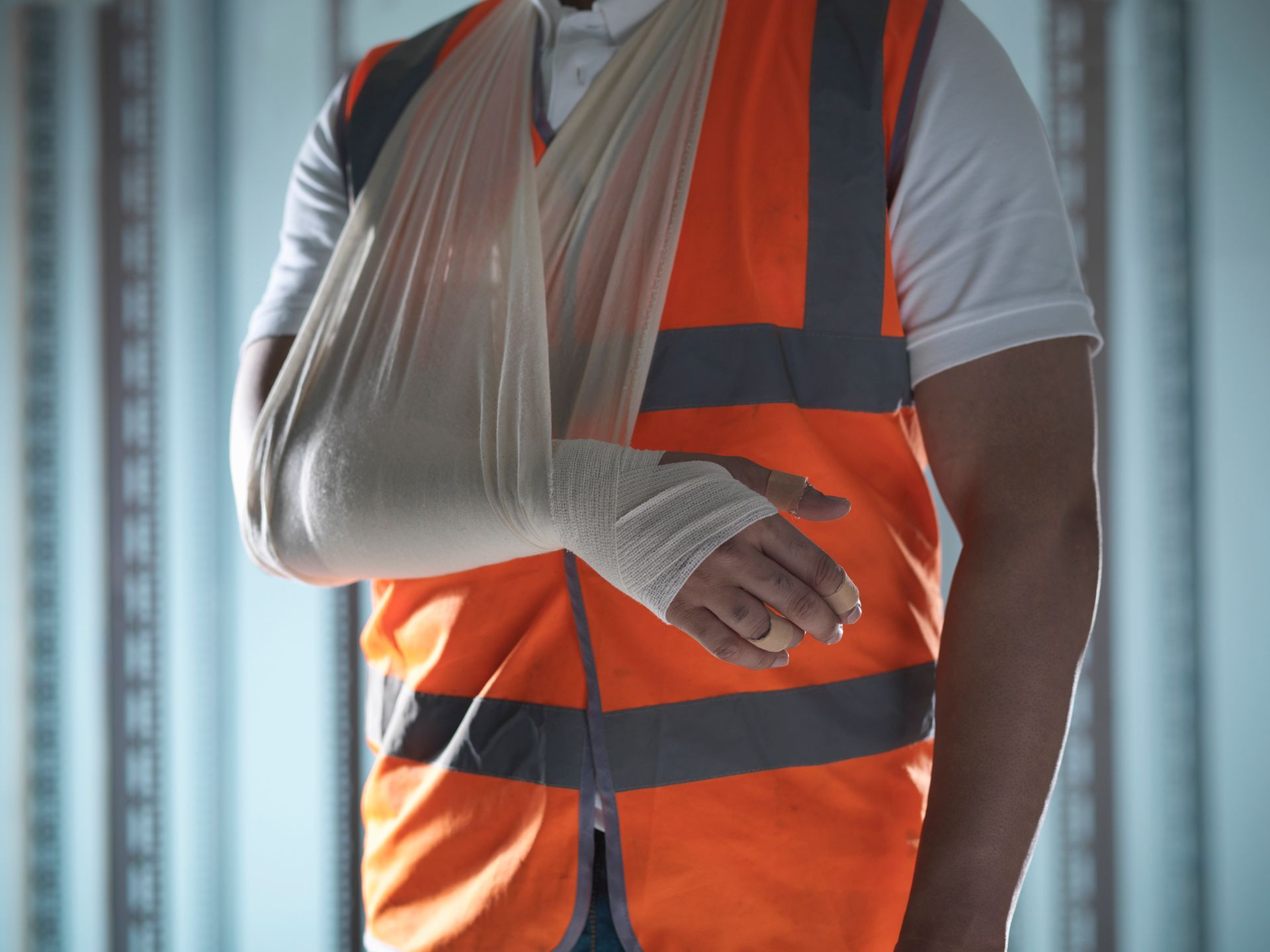 A construction worker with a broken arm in a cast.