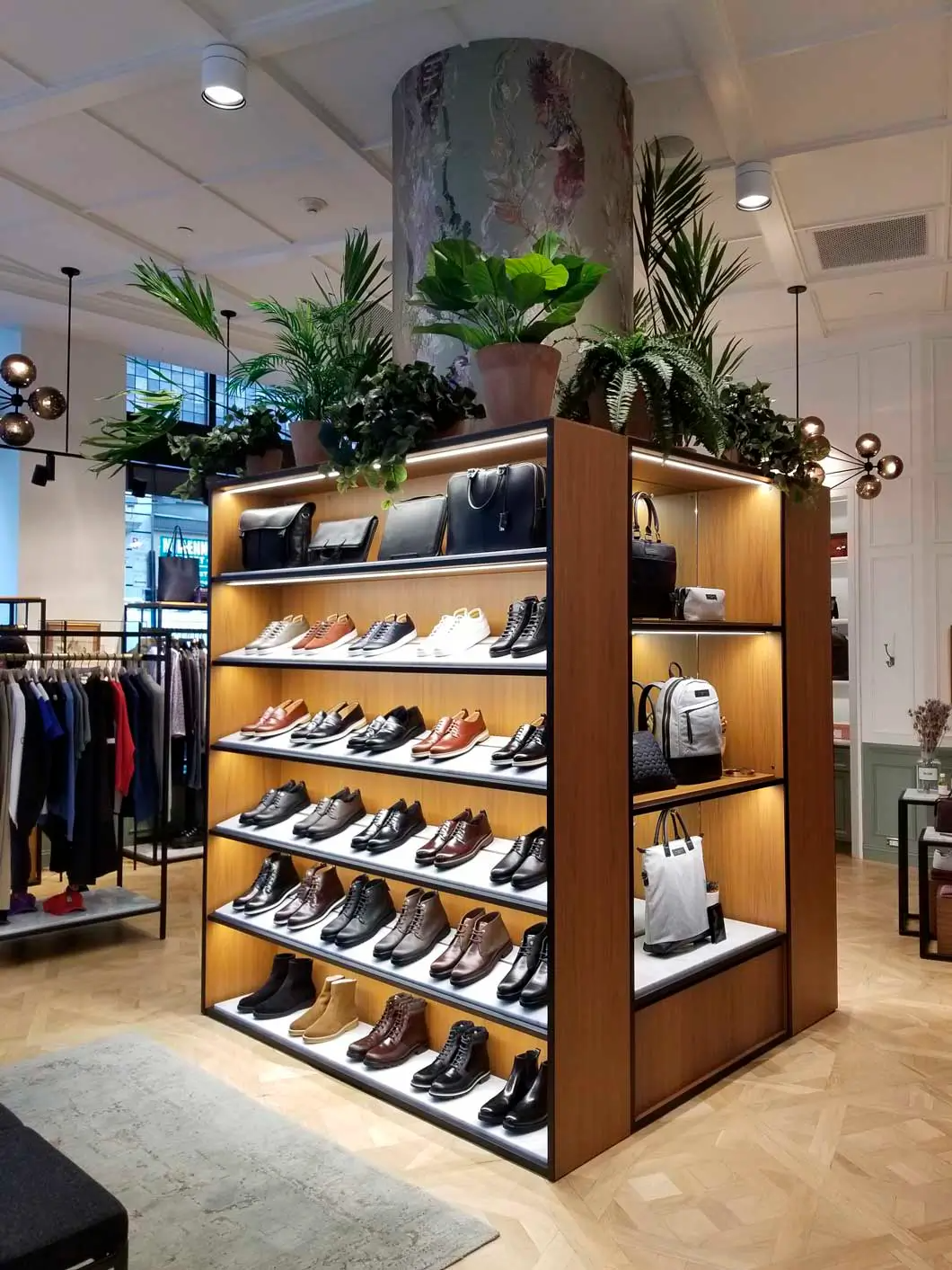 A store filled with lots of shoes and bags on shelves.