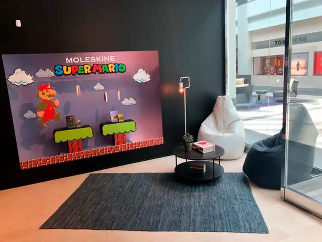 A room with a super mario poster on the wall