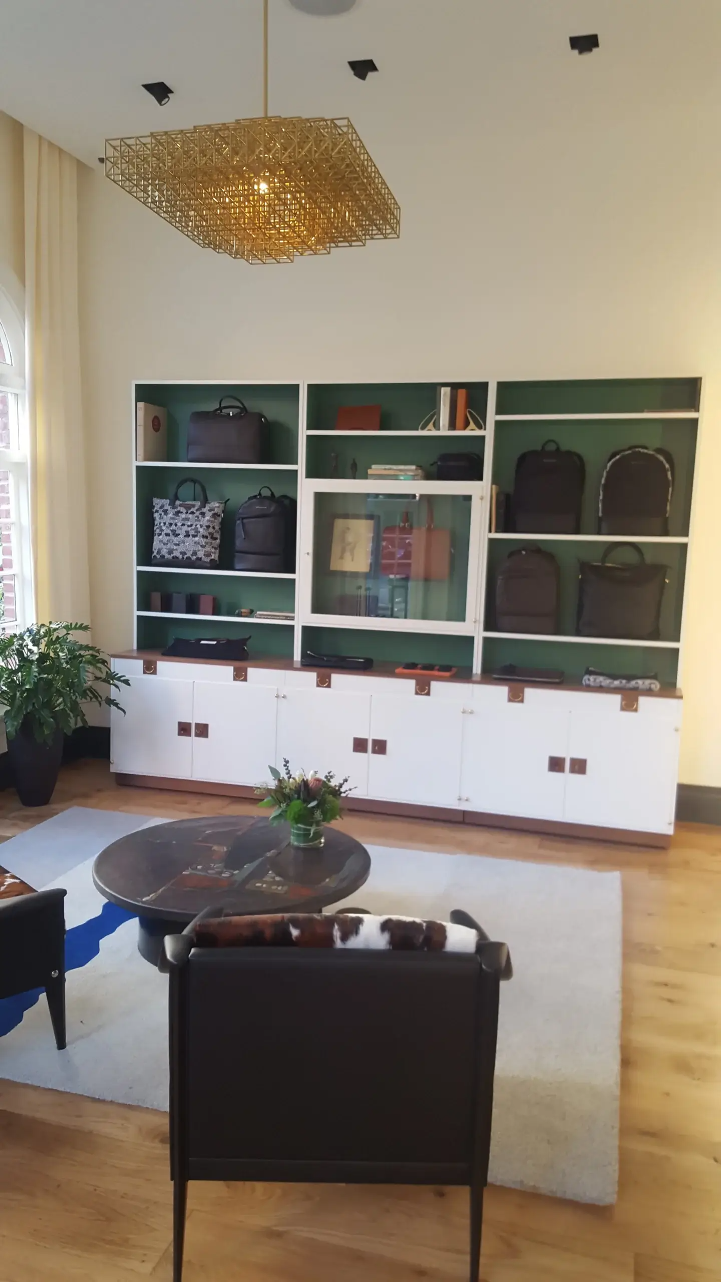 A living room with a lot of shelves and a table