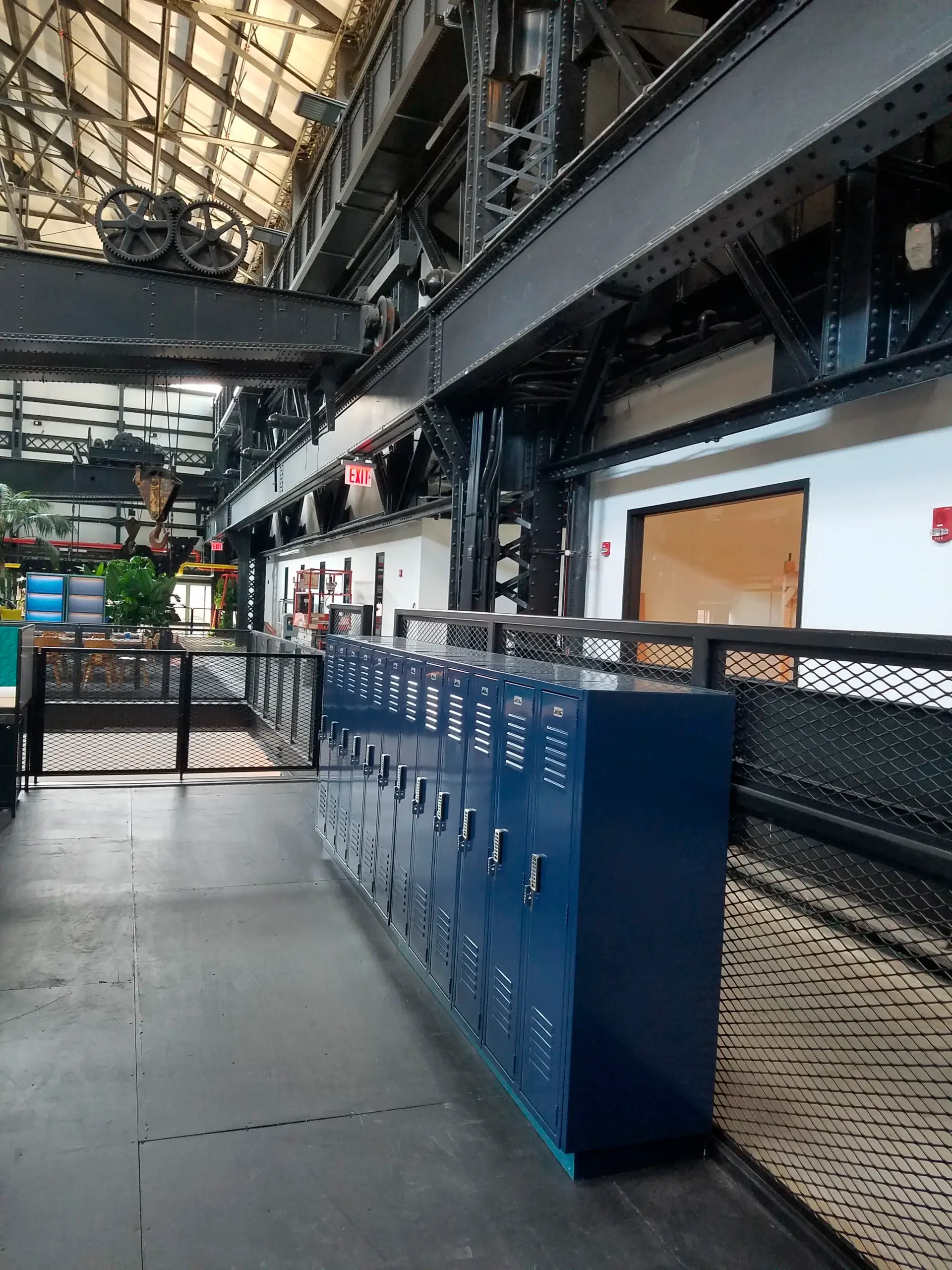 A row of blue lockers are lined up in a building.
