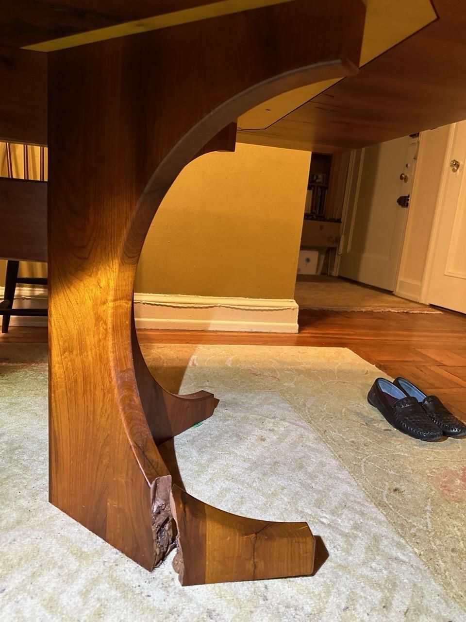 A wooden table is sitting on a rug in a room