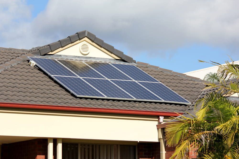 A House with Solar Panels on The Roof — Davey Service & Maintenance Qld In Clinton, QLD