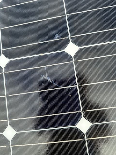 A Close up Of a Solar Panel with A Reflection of A Person in It — Davey Service & Maintenance Qld In Clinton, QLD