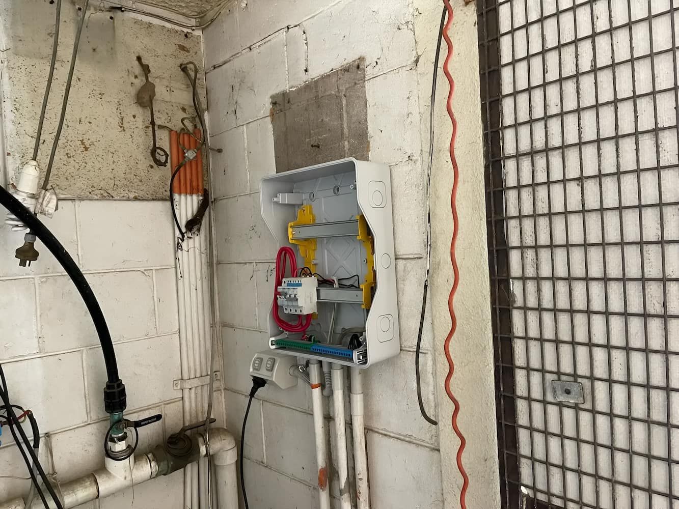 There Is An Electrical Box On The Wall With A Bunch Of Wires Coming Out Of It — Davey Service & Maintenance Qld In Clinton, QLD