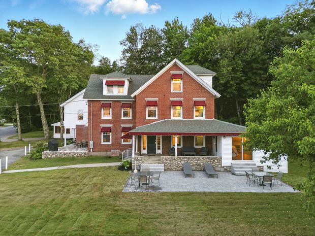 A sunset over a foggy mountain range with trees in the foreground.