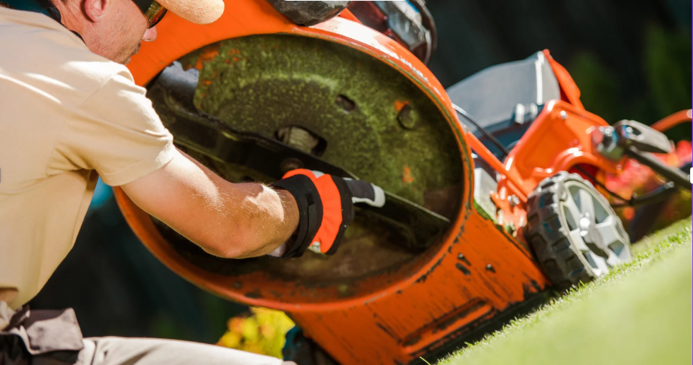 A person is sharpening the mower blade