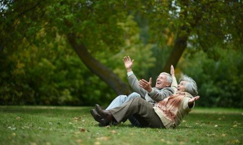 old couple laughing in a park