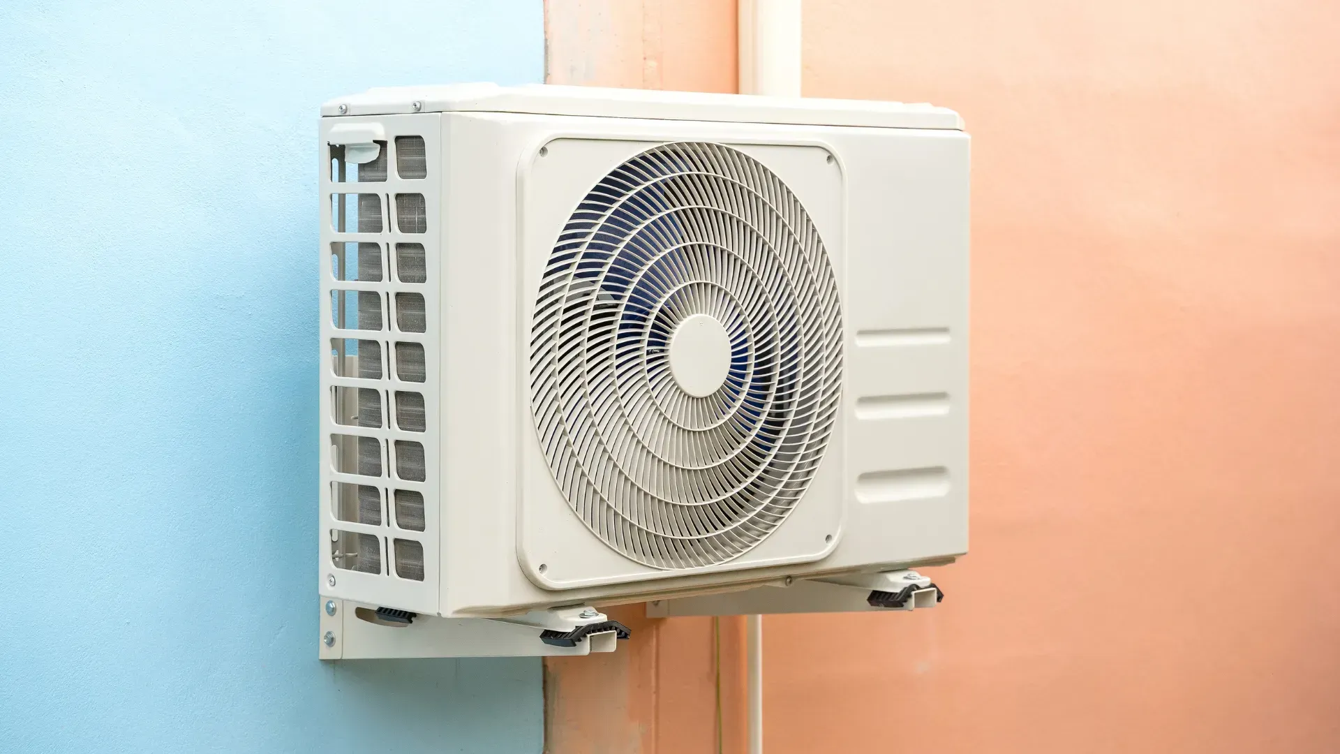 A white air conditioner is mounted on a wall.