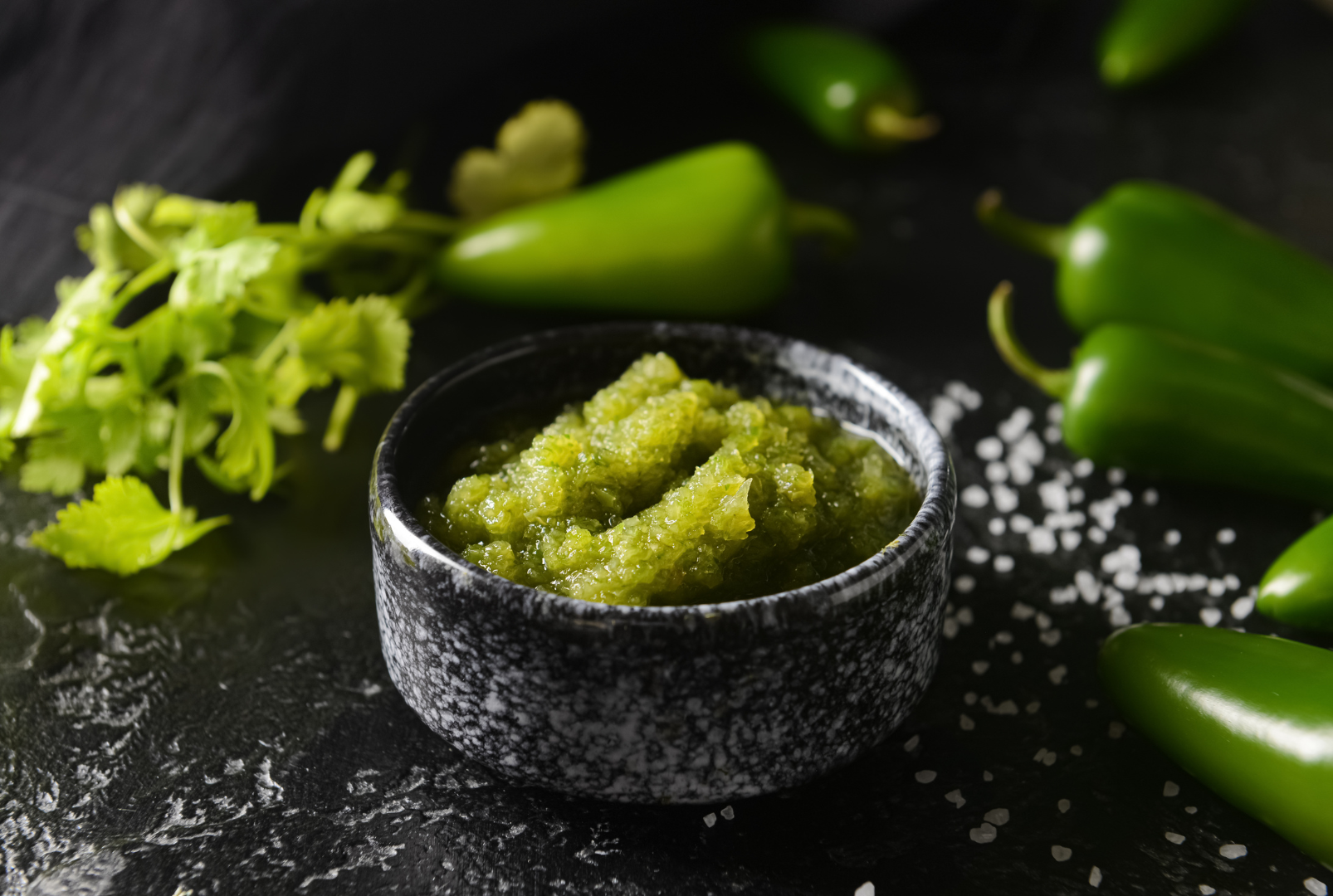 Spices: green cardamom pods, red chili flakes, peppercorns, coriander powder, and dried red chili peppers.