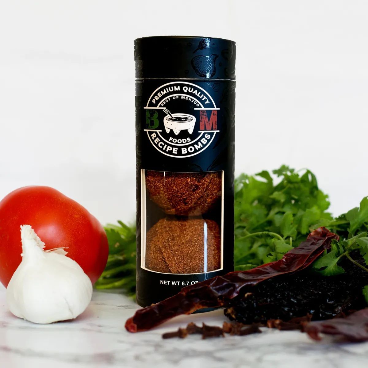 Wooden bowls filled with colorful spices on a dark surface, including turmeric, paprika, and peppercorns.