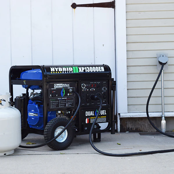 A propane tank is attached to a generator that says hybrid xp13000er