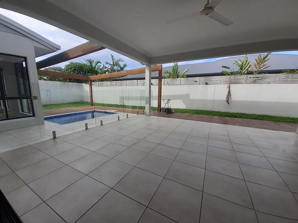 There Is a Swimming Pool in The Backyard of A House — Cairns Vacate Clean in Manunda, QLD