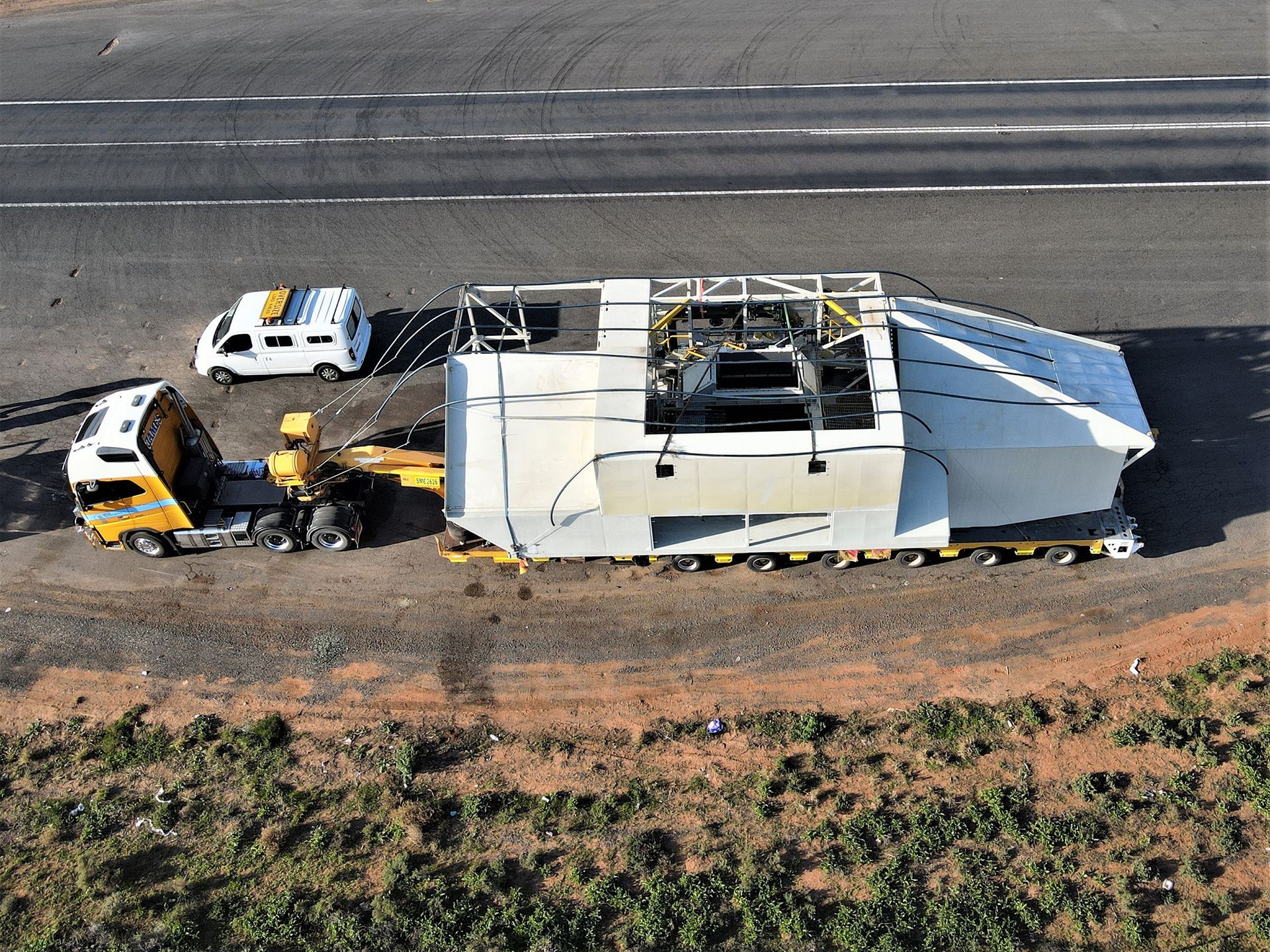 An aerial view of a truck carrying a large object