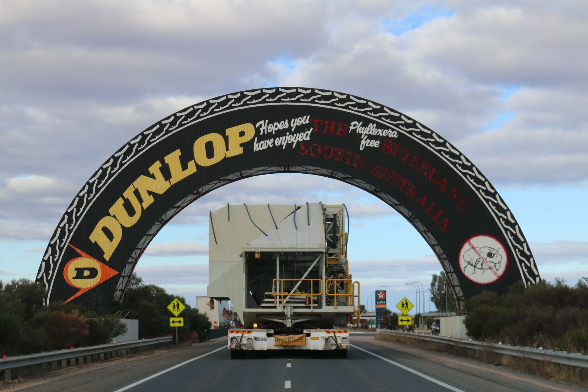 A dunlop sign is on the side of a highway