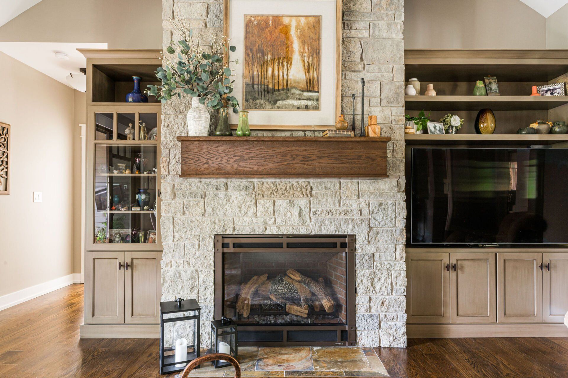 A living room with a fireplace and a television.