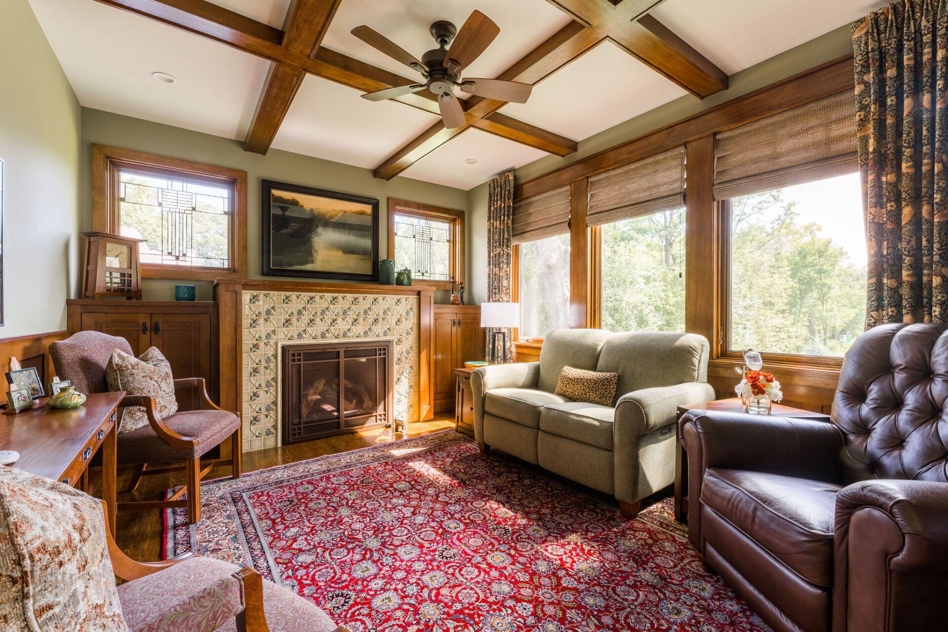 A living room with a couch , chairs , and a fireplace.