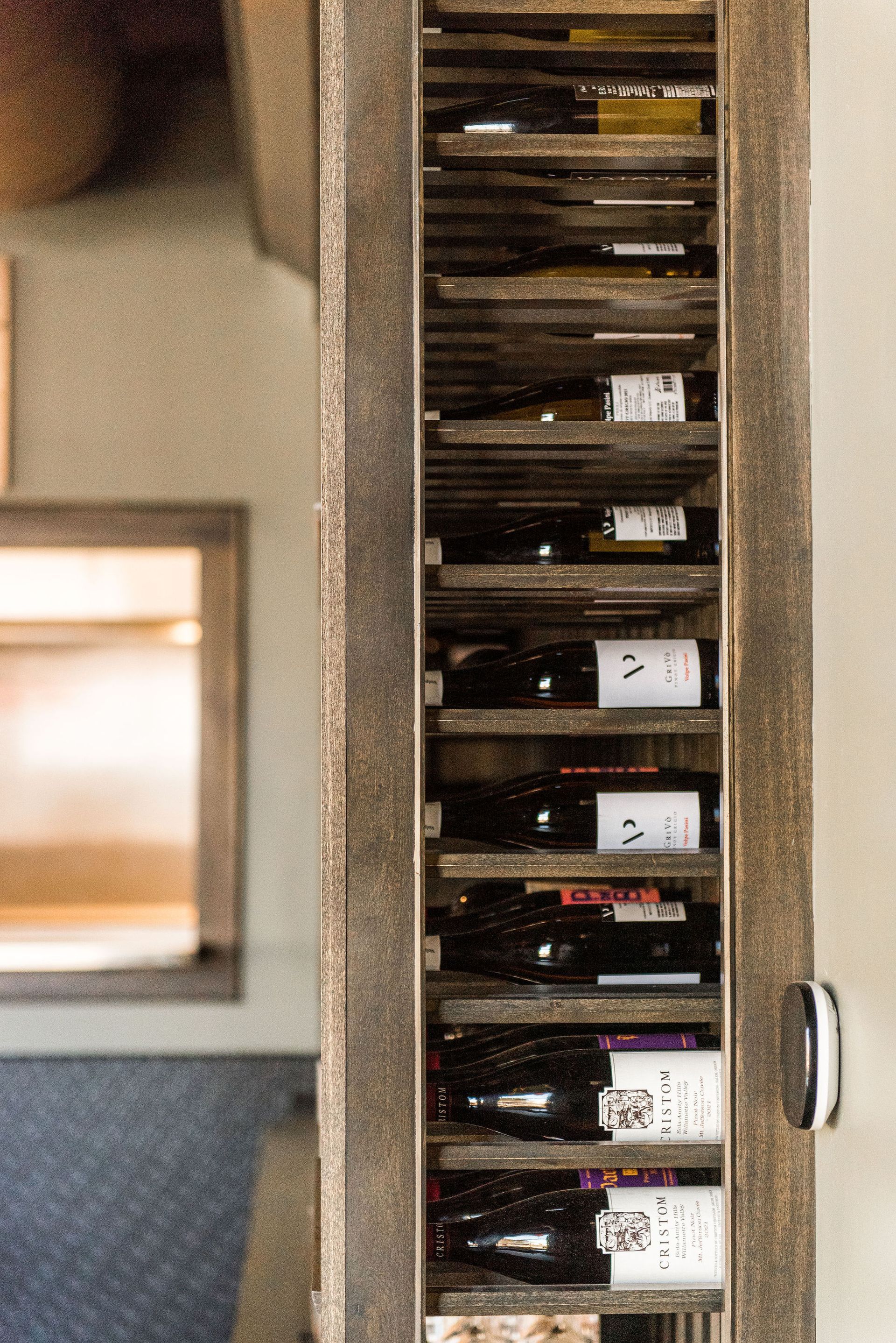 A wooden wine rack filled with bottles of wine.