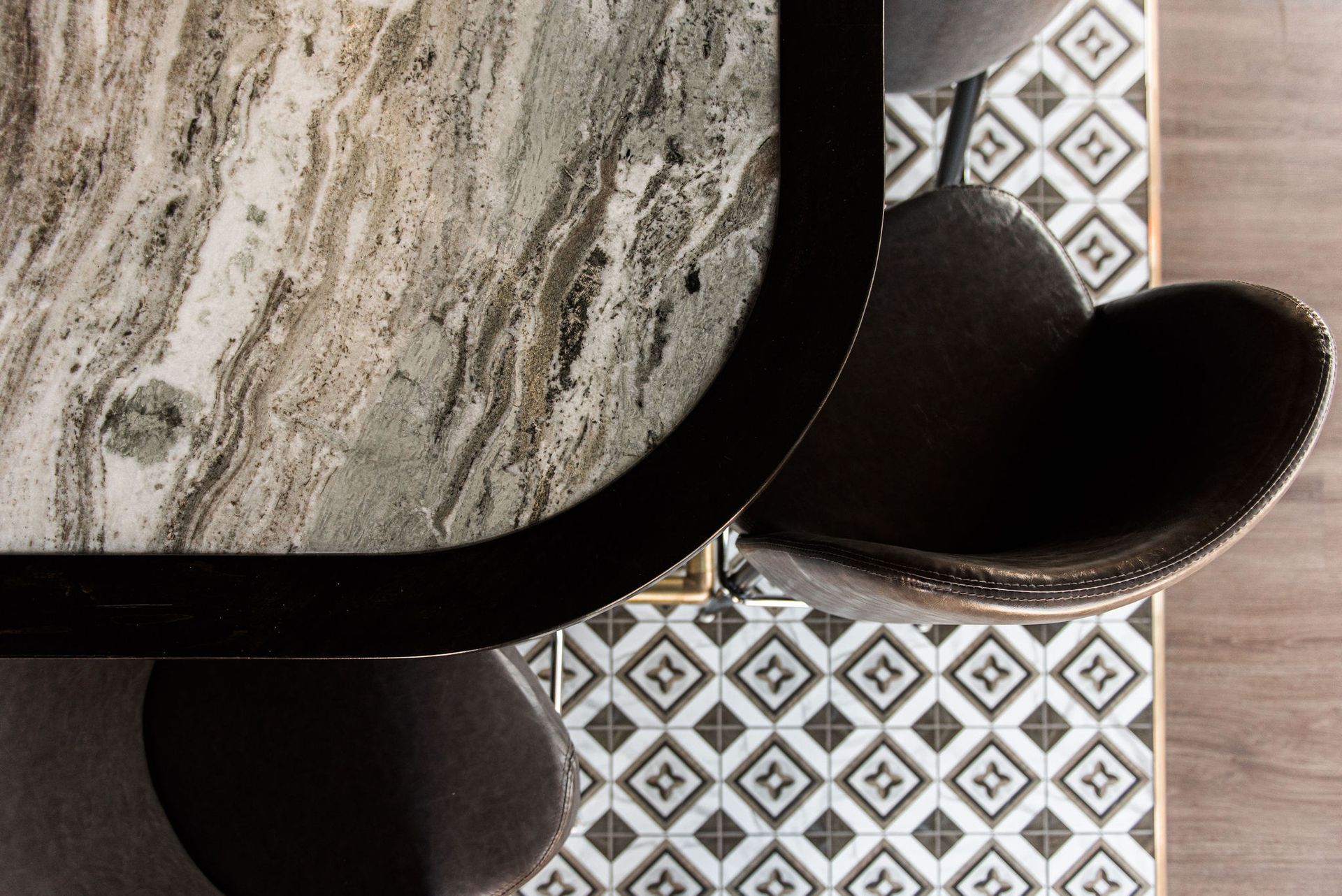 A table and chairs are sitting on top of a tiled floor.