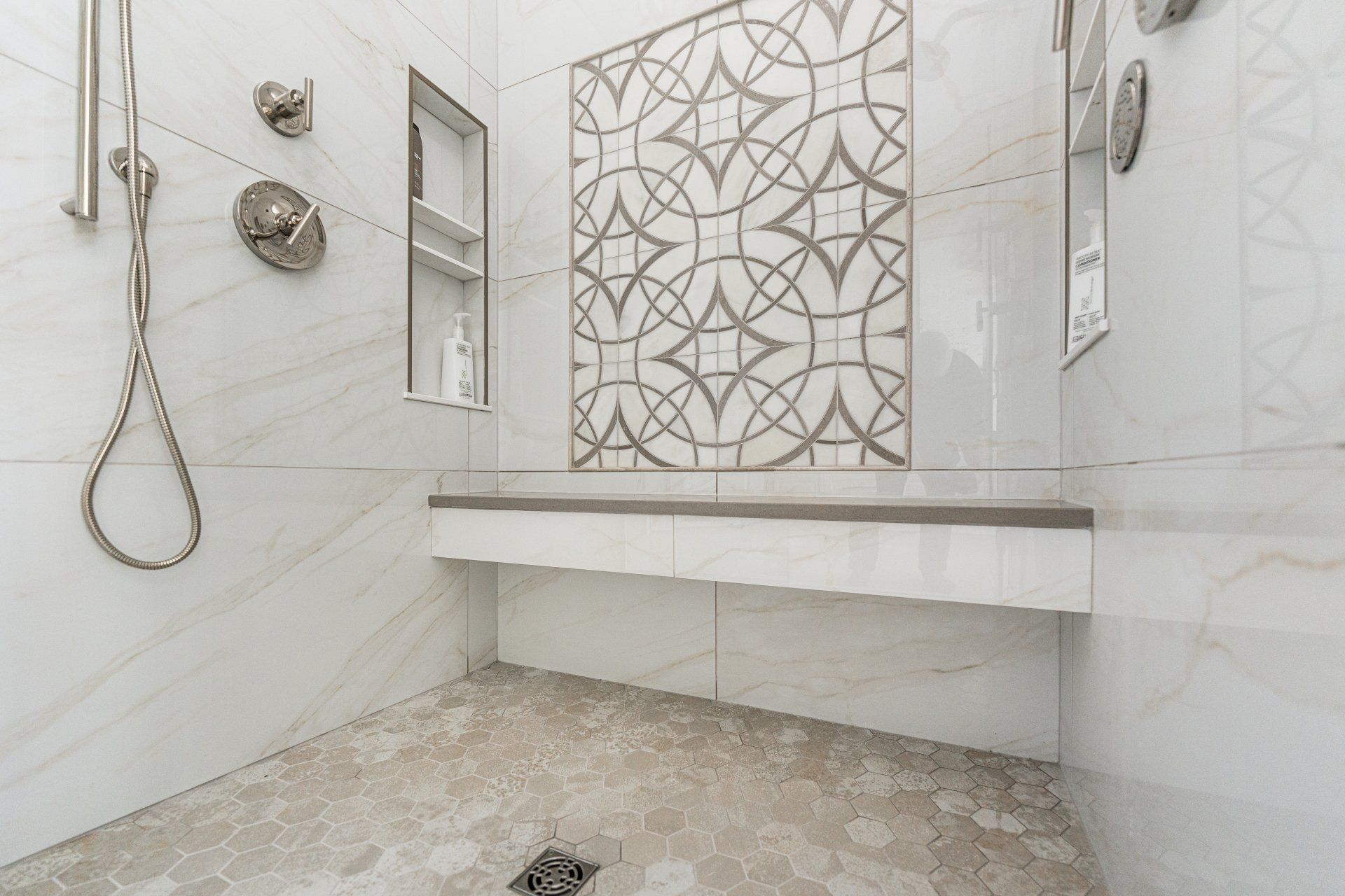 A bathroom with a walk in shower and a bench.