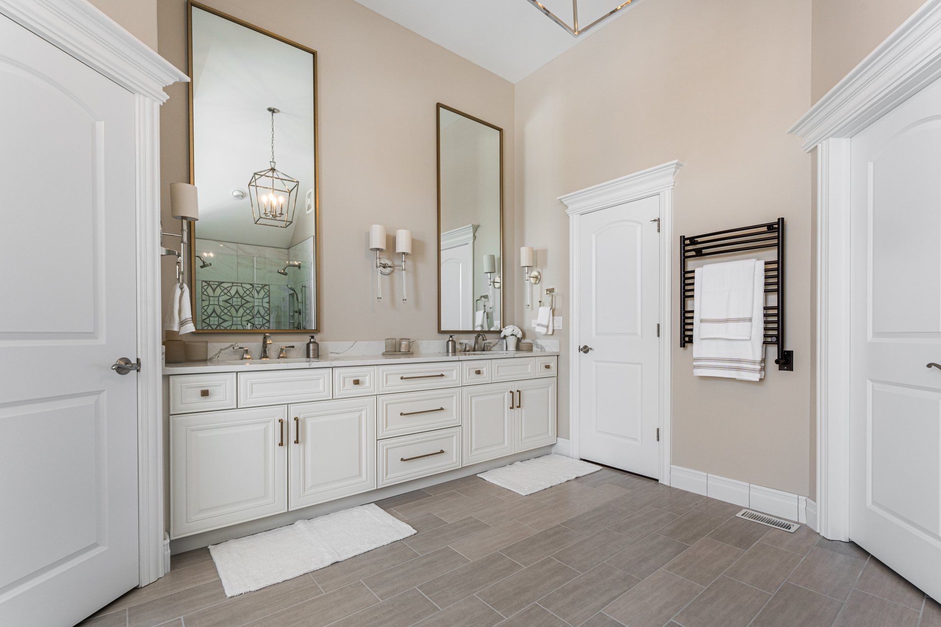 A bathroom with two sinks and two mirrors.