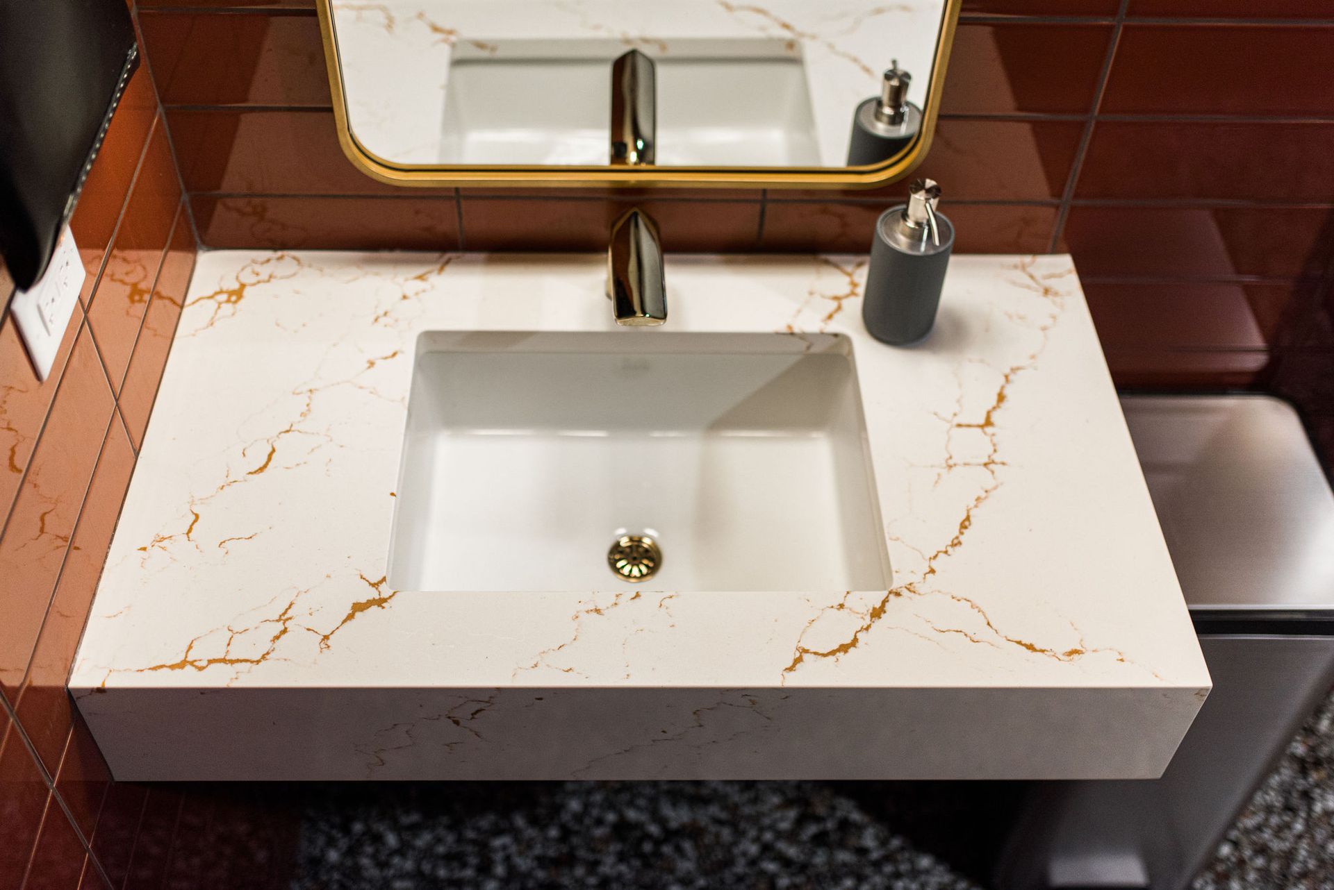 A bathroom sink with a mirror and soap dispenser on it.