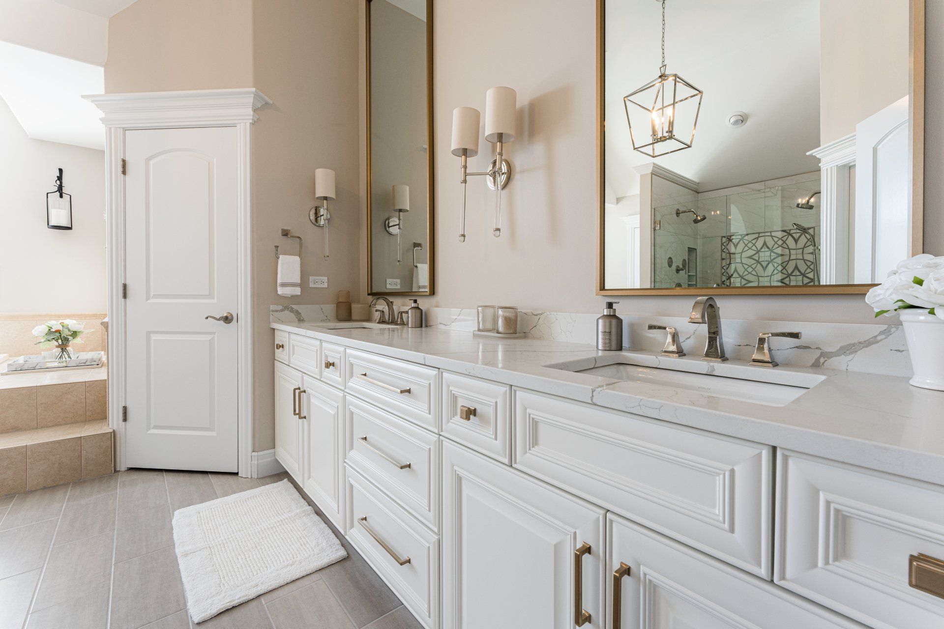 A bathroom with two sinks , a mirror and a bathtub.