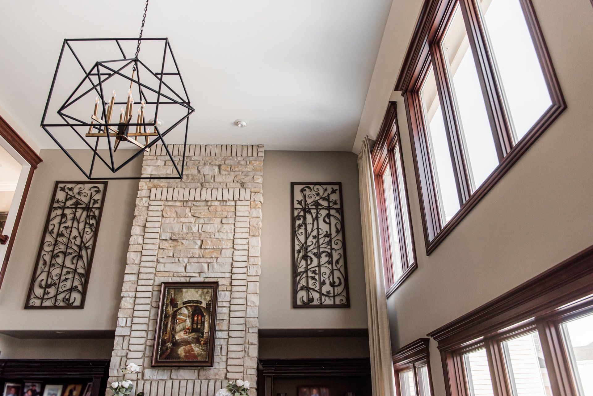 A living room with a fireplace and lots of windows.