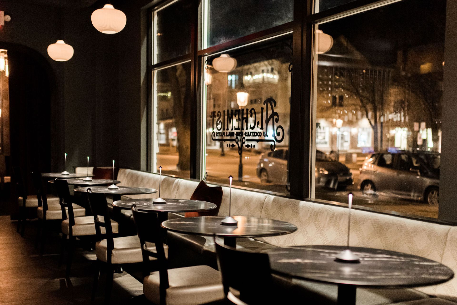 A restaurant with tables and chairs and a large window