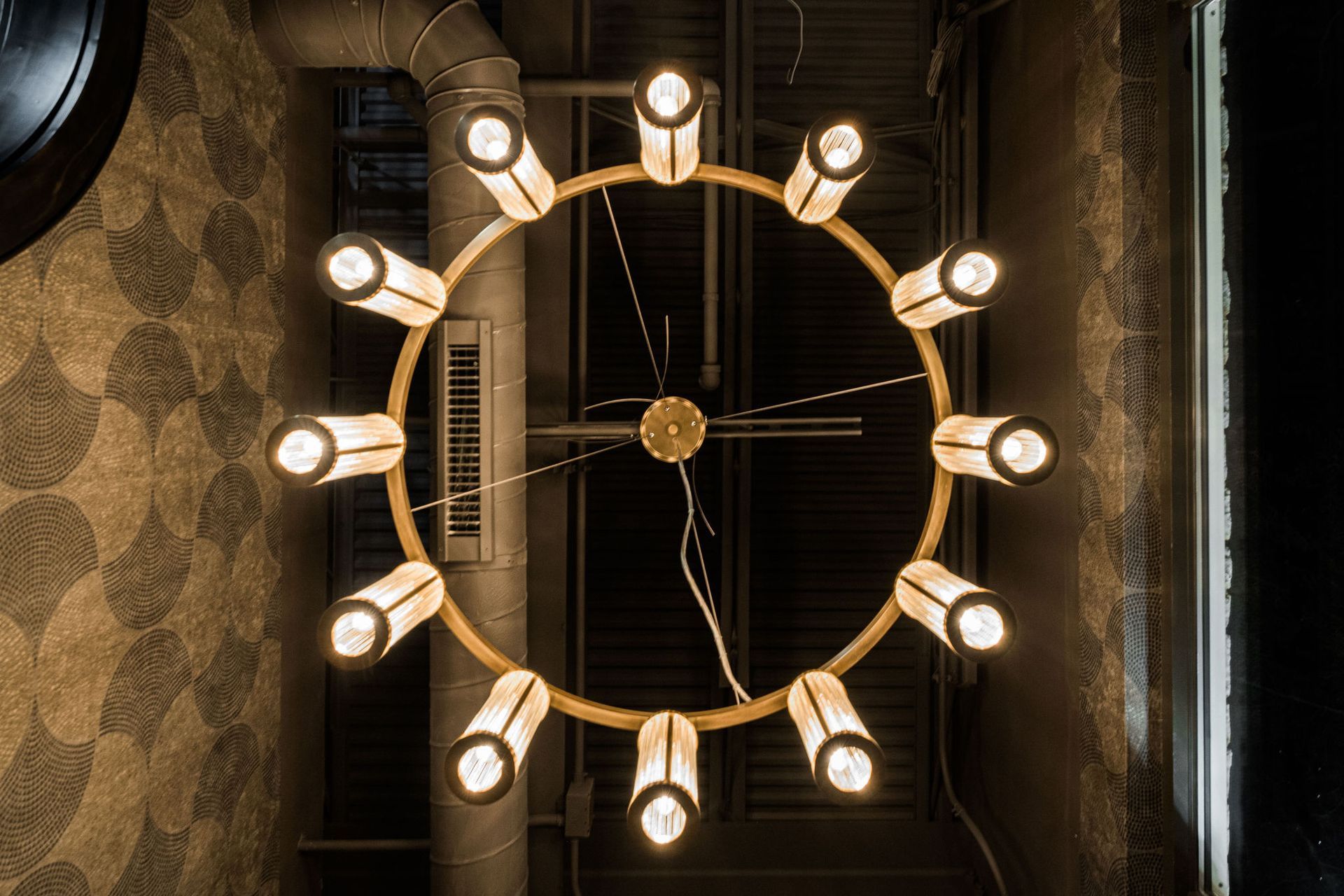 A large chandelier is hanging from the ceiling in a dark room.