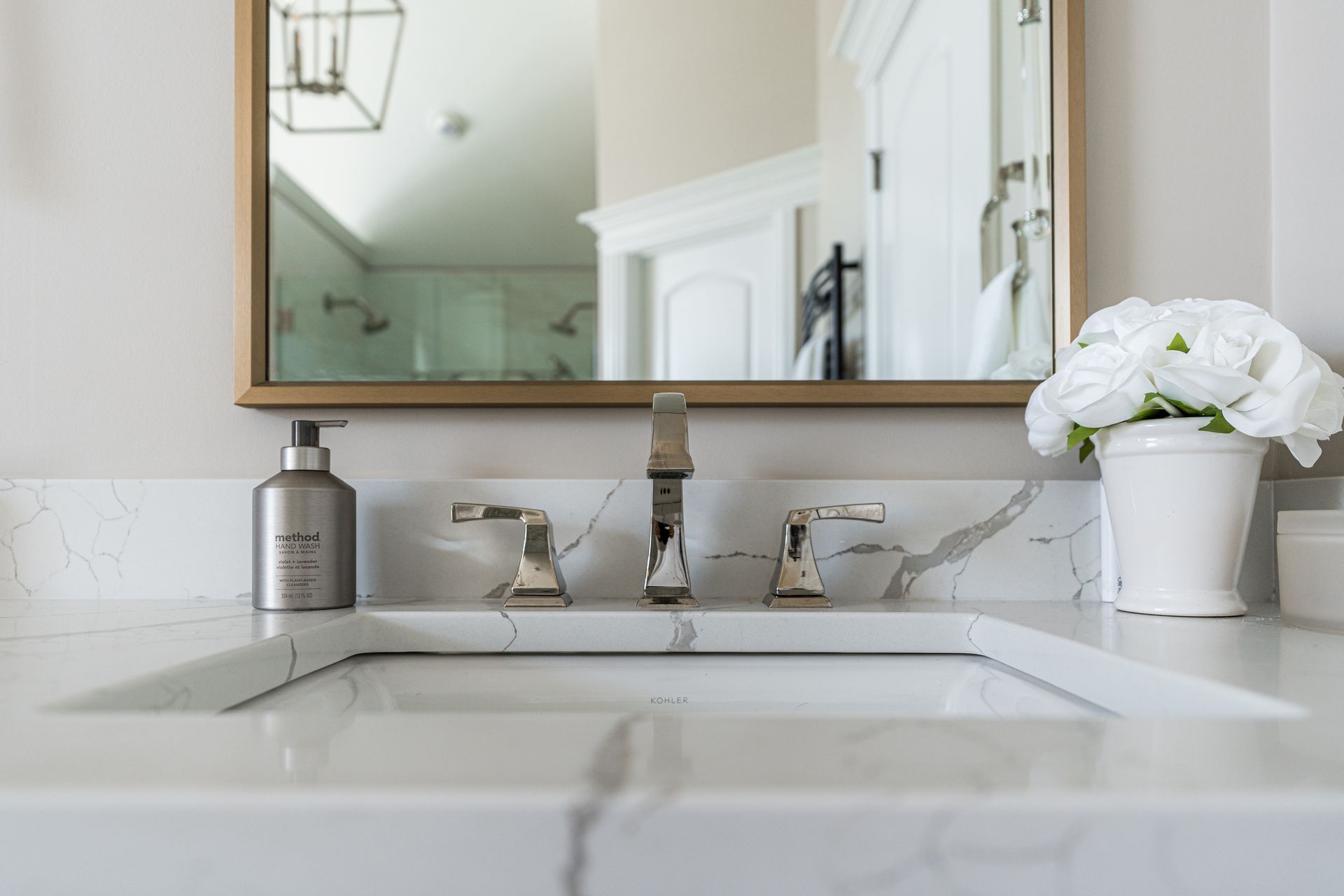 A kitchen sink is sitting under a window in front of a window.